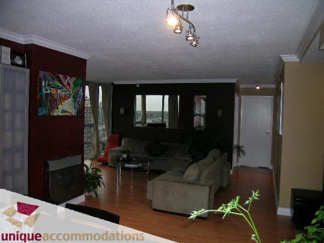 Furnished living room with hardwood floors, city view, and modern lighting. - 2803 - 930 Cambie Street, Vancouver Downtown