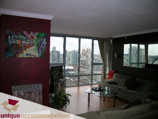 Furnished living room with hardwood floors, city view, and modern decor. - 2803 - 930 Cambie Street, Vancouver Downtown