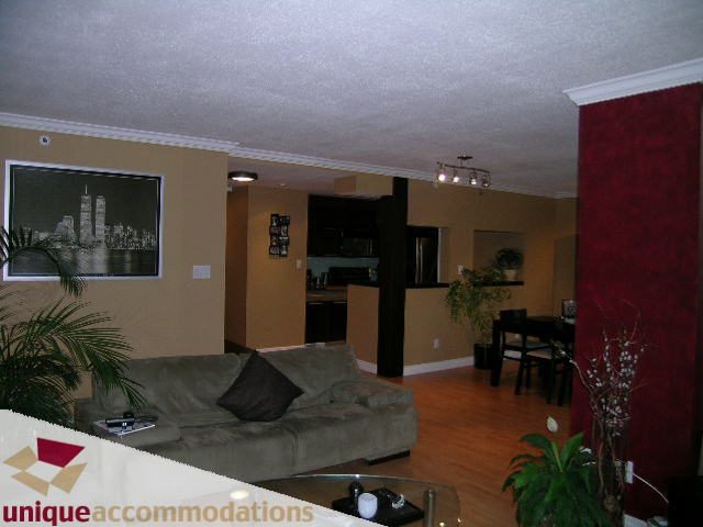 Furnished living room with hardwood floors, city view, and modern decor. - 2803 - 930 Cambie Street, Vancouver Downtown