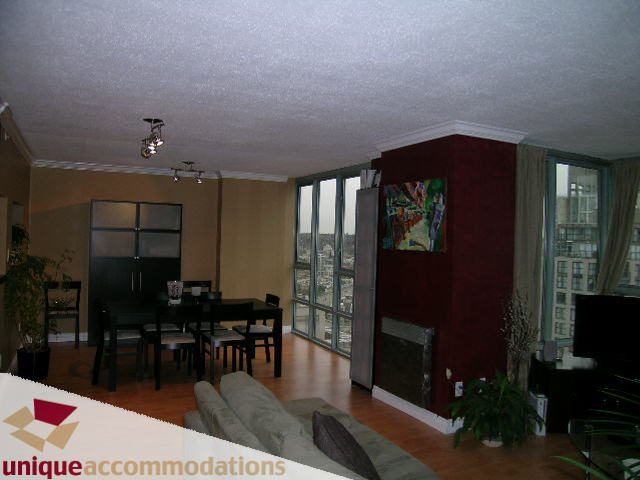 Furnished living room with hardwood floors, city view, and modern decor. - 2803 - 930 Cambie Street, Vancouver Downtown