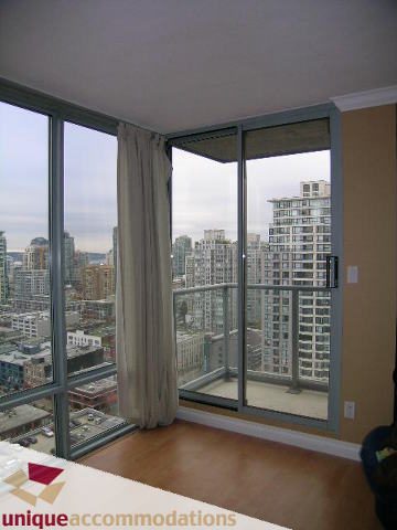 Furnished living room with hardwood floors and a stunning city view. - 2803 - 930 Cambie Street, Vancouver Downtown