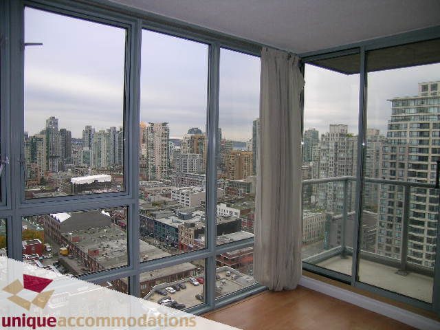 Furnished living room with hardwood floors and a stunning city view. - 2803 - 930 Cambie Street, Vancouver Downtown