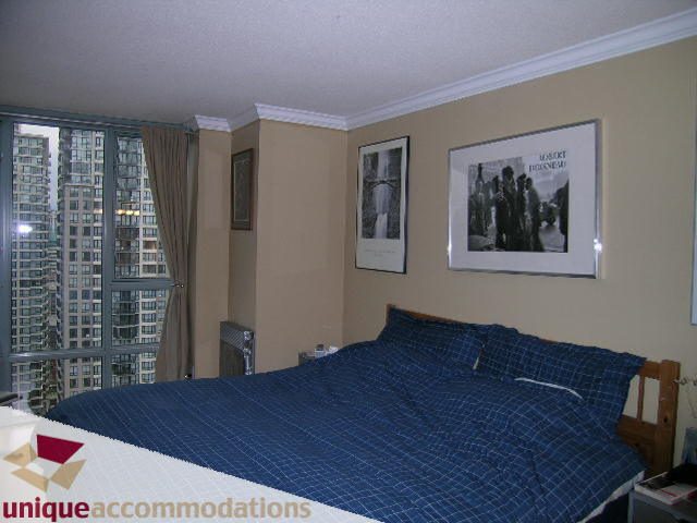 Furnished bedroom with city view and artwork on the wall. - 2803 - 930 Cambie Street, Vancouver Downtown