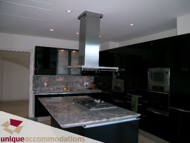 Bright kitchen with granite countertops and stainless steel appliances, modern design. - 104 - 1139 West Cordova Street, Vancouver Downtown