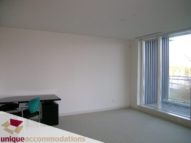 Bright living room with large windows and modern furniture. - 104 - 1139 West Cordova Street, Vancouver Downtown