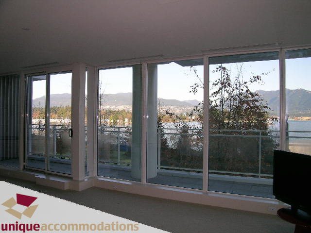 Spacious living room with large windows offering a stunning city view. - 104 - 1139 West Cordova Street, Vancouver Downtown