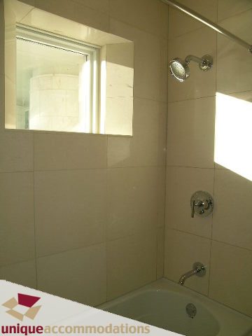 Bathroom with white tiles, shower, and bathtub. - 104 - 1139 West Cordova Street, Vancouver Downtown
