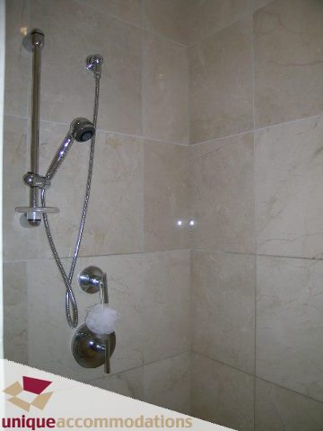 Bathroom with modern shower setup and beige tiles. - 104 - 1139 West Cordova Street, Vancouver Downtown