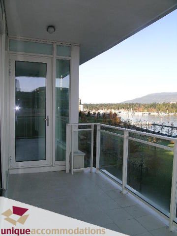 Furnished balcony with glass railings, city view, and modern decor. - 104 - 1139 West Cordova Street, Vancouver Downtown