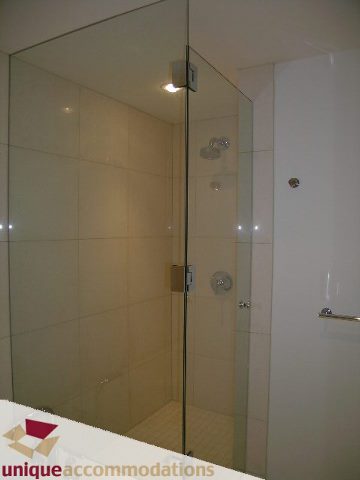 Furnished bathroom with glass shower and white cabinetry. - 104 - 1139 West Cordova Street, Vancouver Downtown