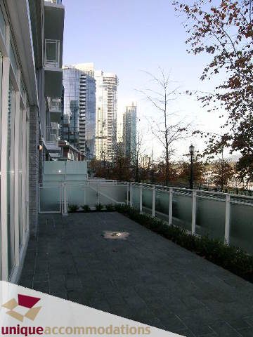 Furnished patio with city view and modern architecture. - 104 - 1139 West Cordova Street, Vancouver Downtown