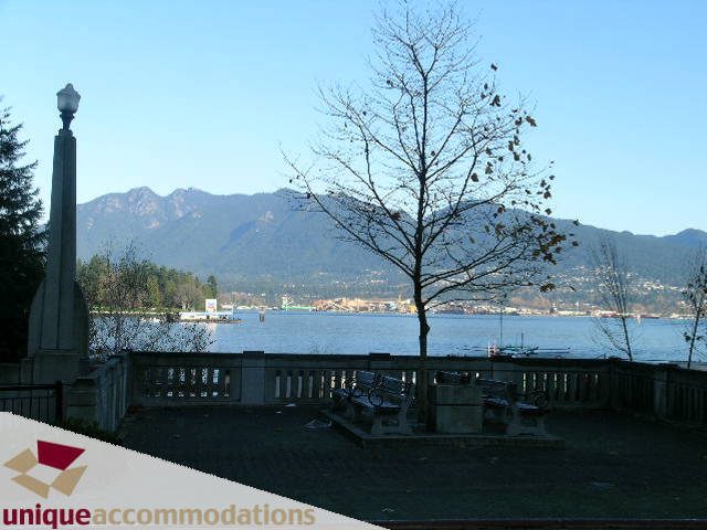 Furnished living room with city view and mountain backdrop. - 104 - 1139 West Cordova Street, Vancouver Downtown