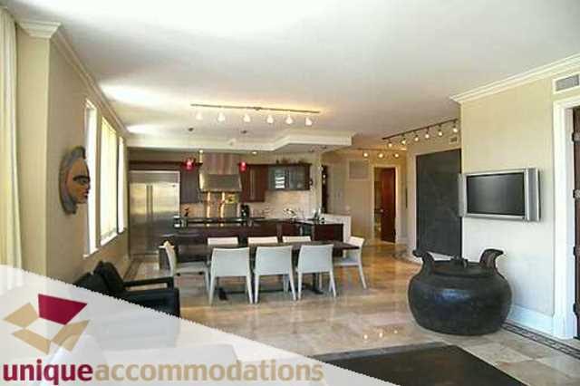 Furnished living room with hardwood floors, modern furniture, and a kitchen in the background. - 403 - 499 Drake Street, Vancouver Downtown