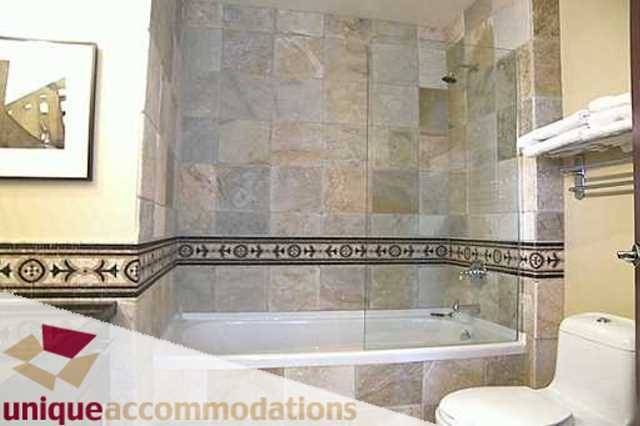 Furnished bathroom with mosaic tile accents and glass shower. - 403 - 499 Drake Street, Vancouver Downtown