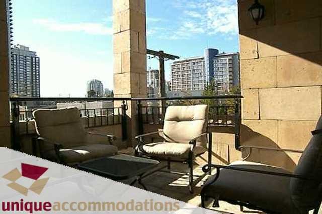 Furnished balcony with city view, comfortable seating, and modern decor. - 403 - 499 Drake Street, Vancouver Downtown