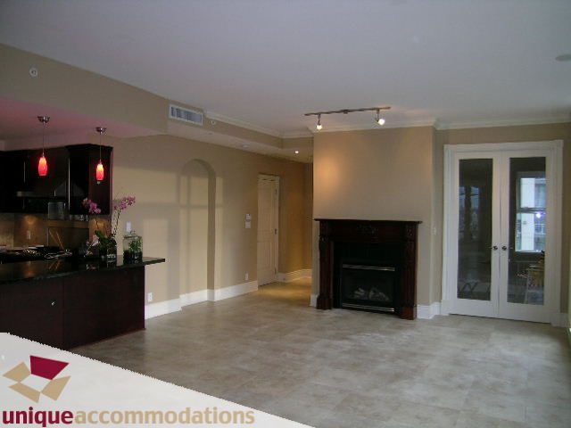 Furnished living room with hardwood floors and modern kitchen in the background. - 1901 - 1280 Richards Street, Vancouver Downtown