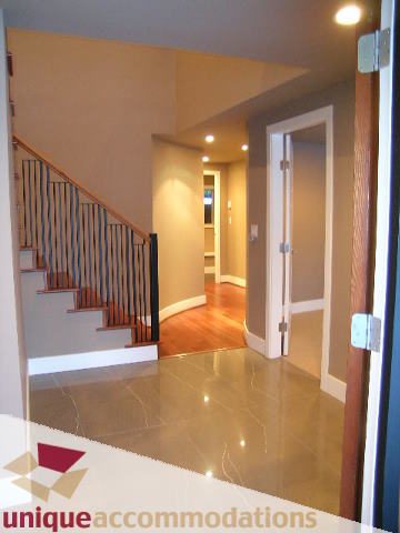 Bright hallway with hardwood floors and modern railings. - 811 Huntingdon Crescent, North Vancouver