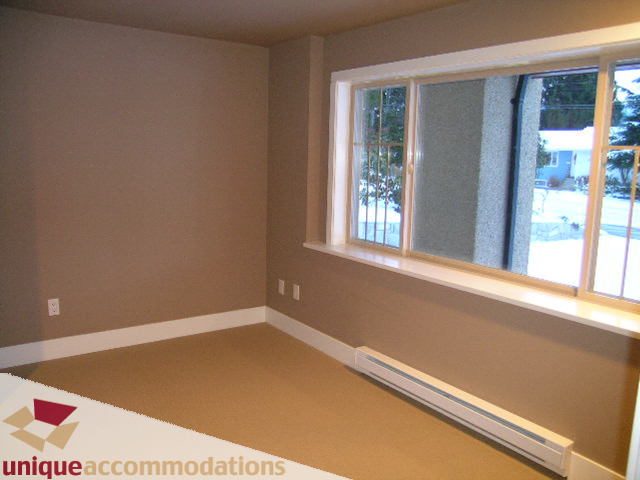 Bright sunroom with large windows and built-in seating, offering a serene outdoor view. - 811 Huntingdon Crescent, North Vancouver