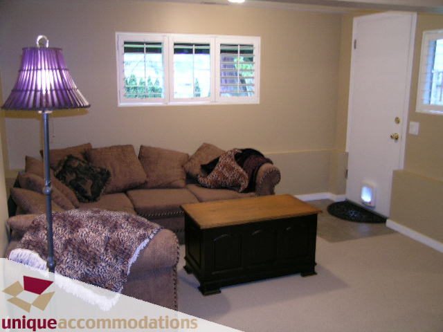 Furnished living room with cozy sectional, floor lamp, and fireplace. - 840 16th Street, West Vancouver