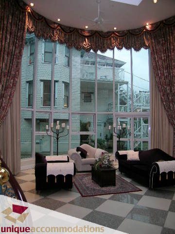 Spacious living room with large windows, checkered floor, and city view. - 1055 West 15th Avenue, Vancouver West Side