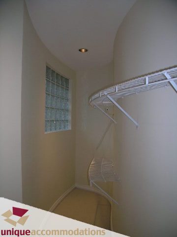Walk-in closet with white shelves and carpeted floor. - 1055 West 15th Avenue, Vancouver West Side