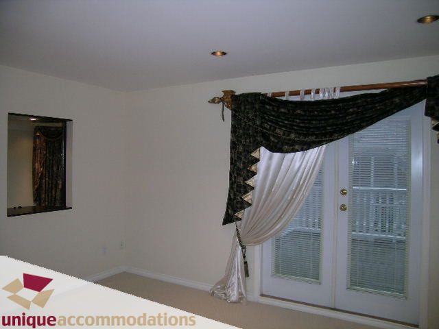 Furnished living room with elegant curtains and a large window. - 1055 West 15th Avenue, Vancouver West Side