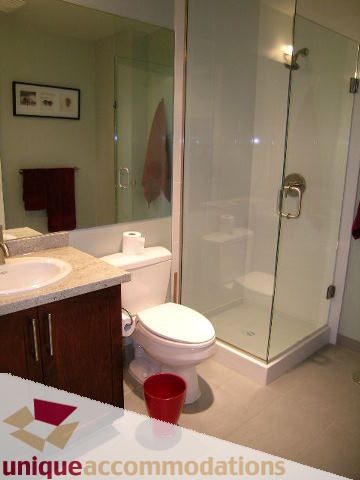 Furnished bathroom with granite countertops and glass shower. - 702 - 2055 Yukon Street, Vancouver West Side