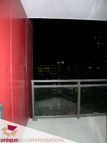 Spacious balcony with city view and modern red accents. - 2701 - 1211 Melville Street, Vancouver Downtown