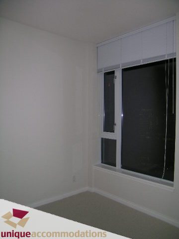 Spacious bedroom with large windows and neutral decor, perfect for a cozy stay. - 2701 - 1211 Melville Street, Vancouver Downtown
