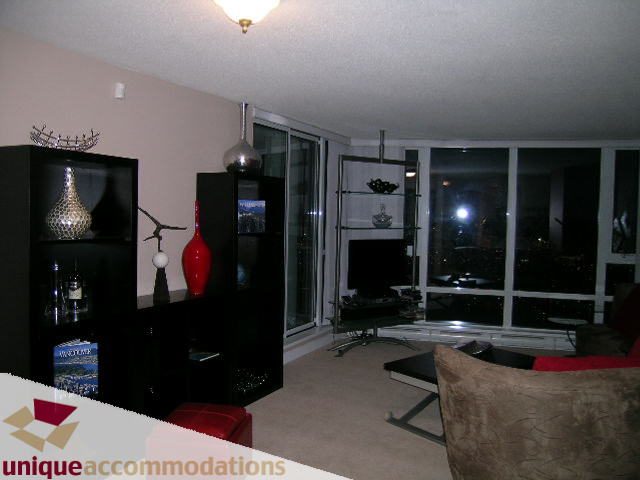 Furnished living room with city view and modern decor. - 4008 - 1408 Strathmore Mews, Vancouver Downtown