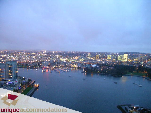 Furnished 2-bedroom condo with stunning city view at dusk. - 4008 - 1408 Strathmore Mews, Vancouver Downtown