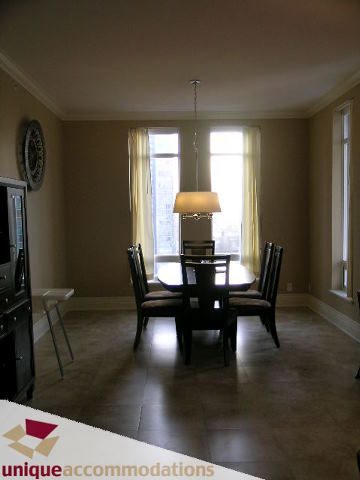 Furnished dining area with large windows, hardwood floors, and a city view. - 1702 - 1280 Richards Street, Vancouver Downtown
