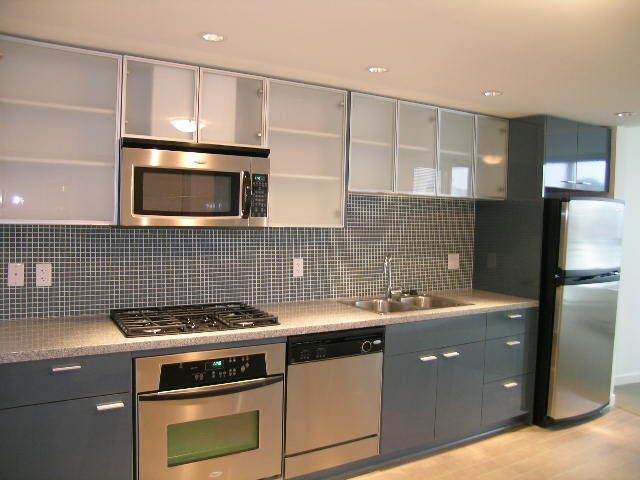 Bright kitchen with modern appliances, gray cabinets, and a sleek countertop. - 3007 - 33 Smithe Street, Vancouver Downtown