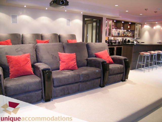 Bright living room with plush seating, red throw pillows, and a bar area. - 2429 West 19th Avenue, Vancouver West Side