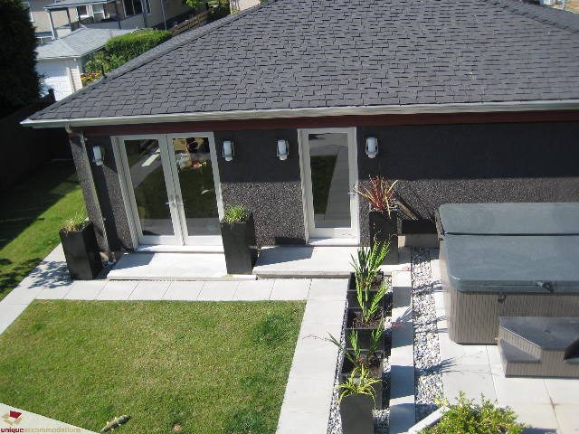 Furnished living room with large windows, modern decor, and outdoor patio access. - 2429 West 19th Avenue, Vancouver West Side