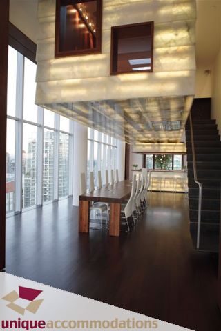 Modern dining area with hardwood floors, city view, and contemporary lighting. - 2601 - 1000 Beach Avenue, Vancouver Downtown