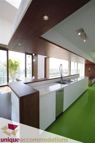 Bright kitchen with white countertops, green flooring, and city view. - 2601 - 1000 Beach Avenue, Vancouver Downtown