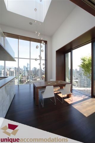 Furnished dining area with hardwood floors and city view. - 2601 - 1000 Beach Avenue, Vancouver Downtown