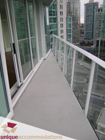 Spacious balcony with glass railings and city views, perfect for relaxing. - 2401-1277 Melville, Vancouver Downtown