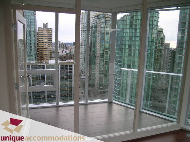 Spacious living room with floor-to-ceiling windows offering a stunning city view. - 2401-1277 Melville, Vancouver Downtown