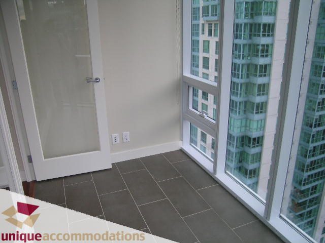 Spacious den with large windows offering stunning city views and modern tile flooring. - 2401-1277 Melville, Vancouver Downtown