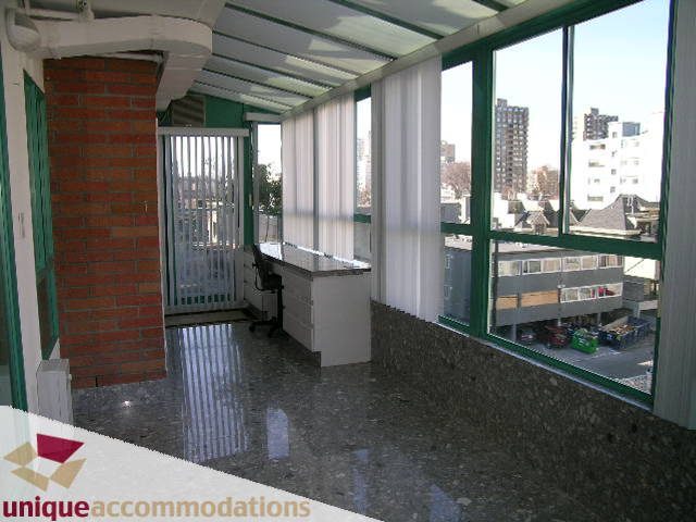 Bright kitchen with large windows, city view, and polished concrete floors. - 703 - 1132 Haro Street, Vancouver Downtown