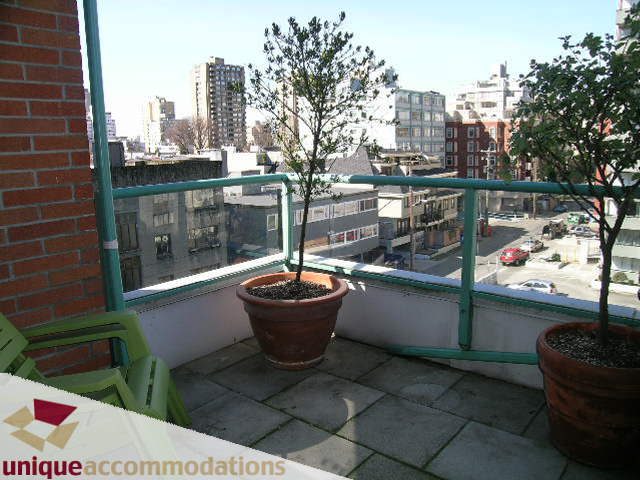 Furnished balcony with city view and potted plants. - 703 - 1132 Haro Street, Vancouver Downtown