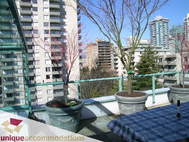 Furnished balcony with potted plants and city view. - 703 - 1132 Haro Street, Vancouver Downtown