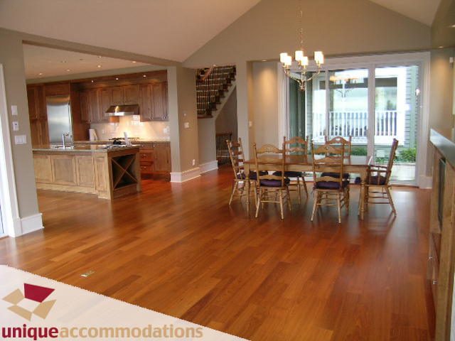 Furnished dining area with hardwood floors and a view of the kitchen. - 2550 Marr Creek Ct, West Vancouver