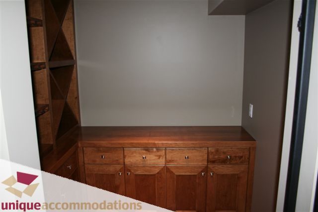 Furnished kitchen with wooden cabinets and countertop. - 2550 Marr Creek Ct, West Vancouver