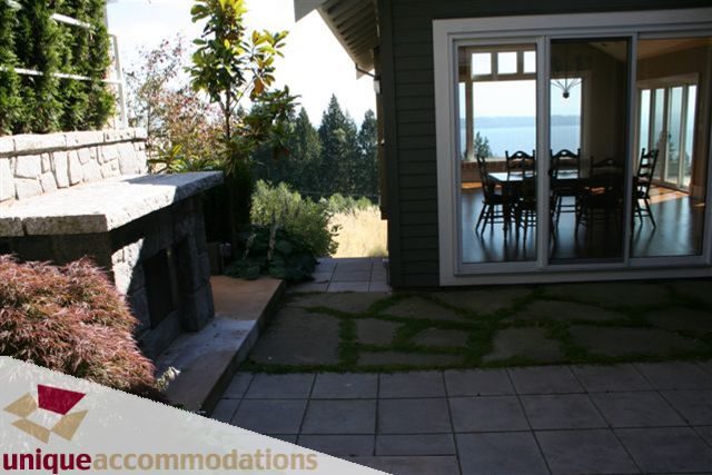 Furnished patio with stone seating and ocean view. - 2550 Marr Creek Ct, West Vancouver