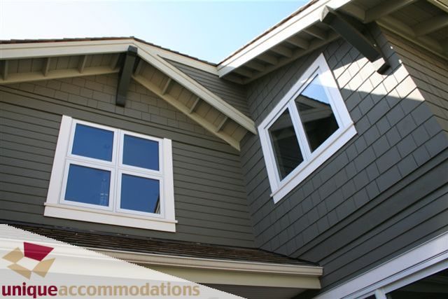 Bright 3rd-floor bedroom with large windows and dark gray siding. - 2550 Marr Creek Ct, West Vancouver