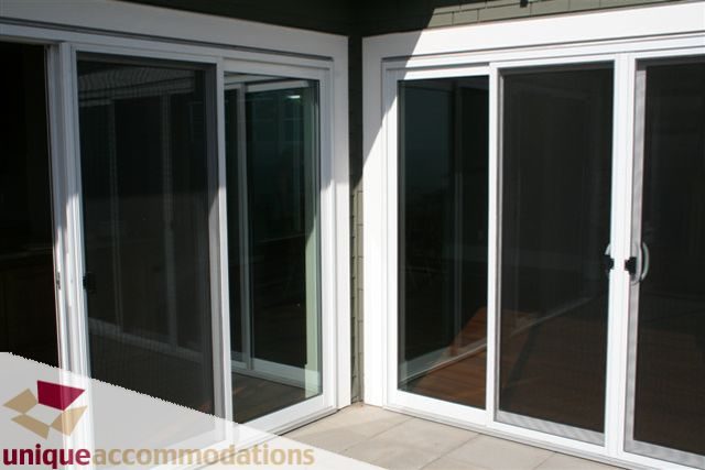 Bright living room with sliding glass doors leading to a patio. - 2550 Marr Creek Ct, West Vancouver