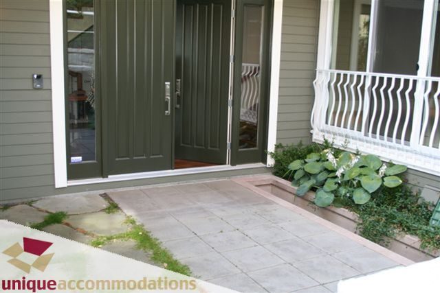 Furnished entryway with green doors and white railing, clean and inviting. - 2550 Marr Creek Ct, West Vancouver